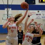 Wrangell High School senior Kiara Harrison (11) rebounds over senior teammate Trinity Faulkner (2) and Petersburg High School sophomores Iris Case (10) and Kylie Mattingly (30) during the Lady Wolves 48-10 win over the Lady Vikings in the Region V 2A/4A Basketball Tournament on Wednesday at Thunder Mountain High School in Juneau. (Klas Stolpe / For the Juneau Empire)