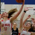 Wrangell High School senior Kiara Harrison (11) rebounds over senior teammate Trinity Faulkner (2) and Petersburg High School sophomores Iris Case (10) and Kylie Mattingly (30) during the Lady Wolves 48-10 win over the Lady Vikings in the Region V 2A/4A Basketball Tournament on Wednesday at Thunder Mountain High School in Juneau. (Klas Stolpe / For the Juneau Empire)