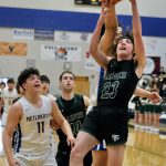 Metlakatlas Aaron OBrien takes a rebound from behind Haines Phoenix Swaner (23) during the Region V tournament on Thursday. (Klas Stolpe / For the Juneau Empire)