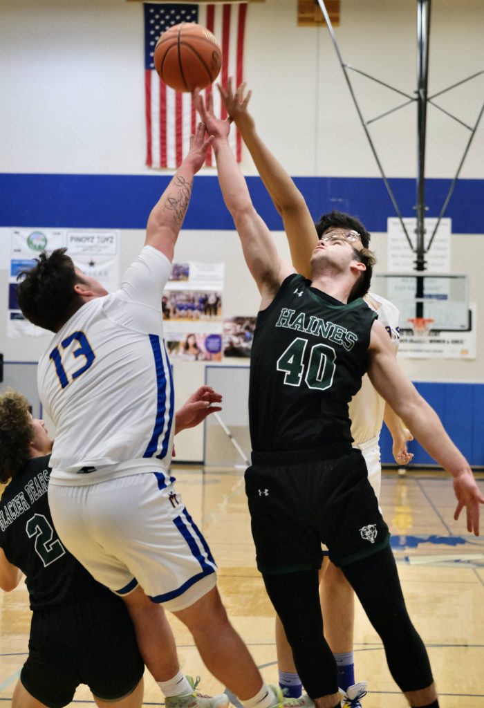 Metlakatlas Cameron Gaube (13) and Aaron OBrien battle for a rebound with Haines Luke Davis (2) and Eric Brouilette (40) during the Region V tournament on Thursday. (Klas Stolpe / For the Juneau Empire)