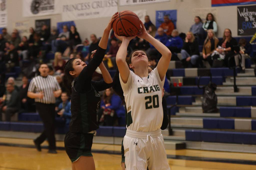 Haines sophomore Ariel Godinez Long (3) gets a hand on the ball as Craig senior Laci Lowery tries to get off a shot in the second half of a Region V 2A Tournament game at Thunder Mountain High School. Craig would hang on to win. (Ben Hohenstatt / Juneau Empire)