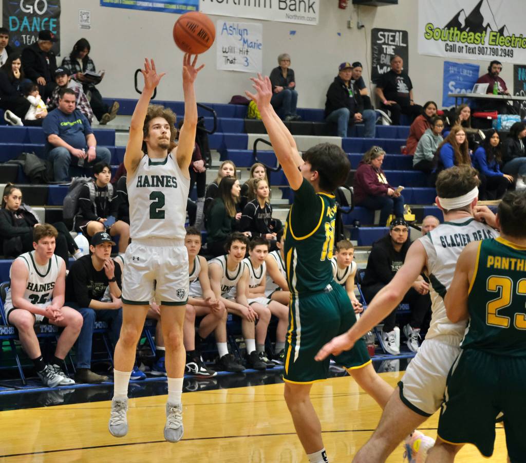 Haines Luke Davis (2) shoots over Craigs Josh Bennett (10) during Region V tournament action Wednesday. (Klas Stolpe / For the Juneau Empire)