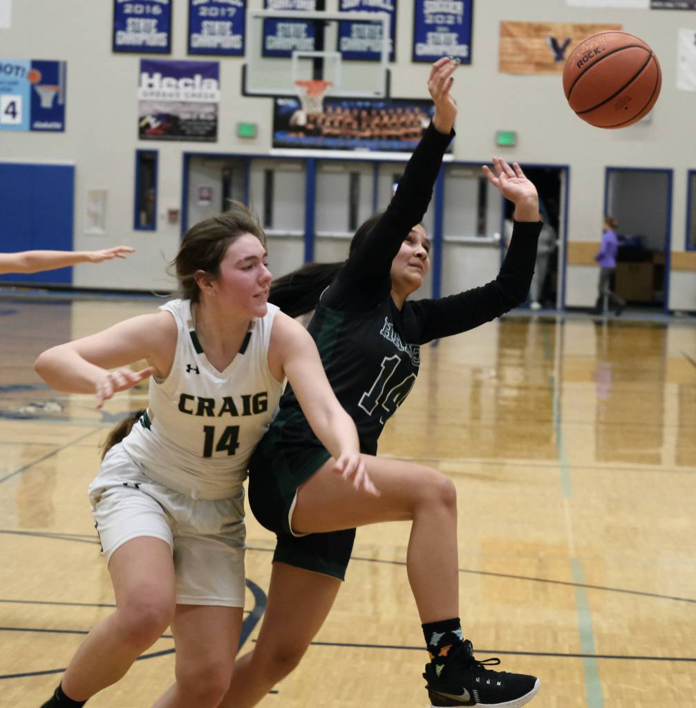 Craigs Alissa Durgan and Haines Alison Benda chase a rebound during the Region V tournament on Wednesday. (Klas Stolpe / For the Juneau Empire)