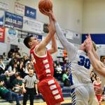 Wrangells Daniel Harrison (34) has his jump shot contested by Petersburgs Hunter Conn (30) during the Region V tournament on Wednesday. (Klas Stolpe / For the Juneau Empire)