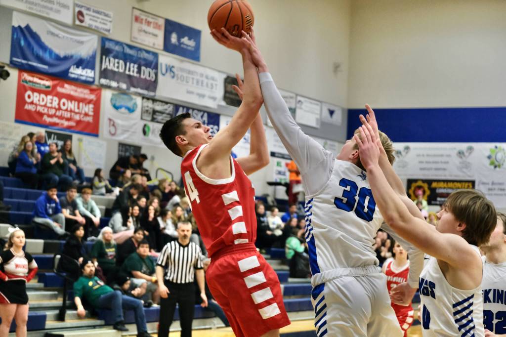 Wrangells Daniel Harrison (34) has his jump shot contested by Petersburgs Hunter Conn (30) during the Region V tournament on Wednesday. (Klas Stolpe / For the Juneau Empire)