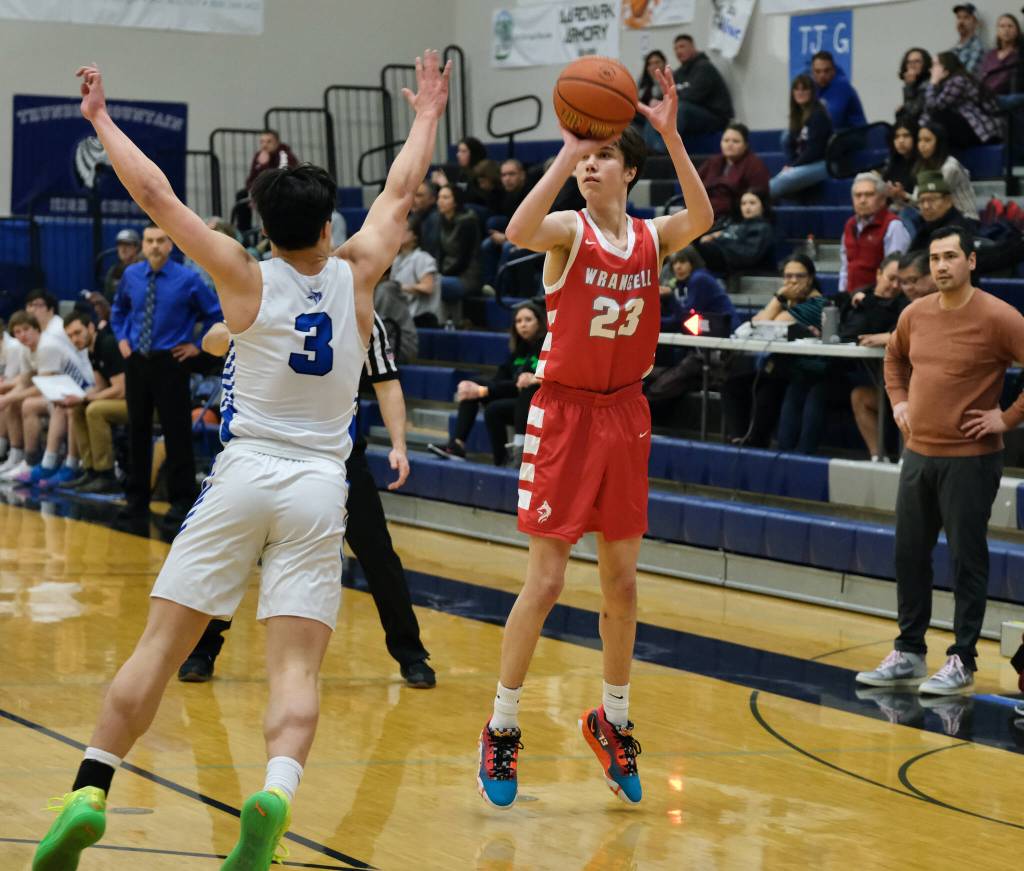 Wrangells Jacen Hay (23) lines up a shot against Petersburgs Rik Cumps (3) during Region V tournament action on Wednesday. (Klas Stolpe / For the Juneau Empire)