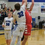 Petersburgs Jack Engell challenges a shot by Wrangells Ethan Blatchley (12) during Region V tournament action on Wednesday.(Klas Stolpe / For the Juneau Empire)