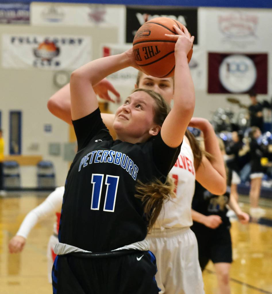 Petersburgs Anya Pawuk (11) shoots in front of Wrangells Kiara Harrison during the Region V tournament on Wednesday. (Klas Stolpe / For the Juneau Empire)