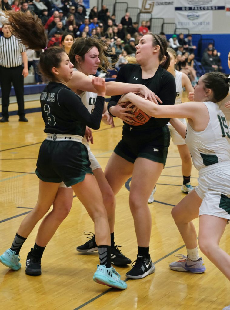 Craig High School senior Alissa Durgan and Amiaya Hansen (15) battle for a ball with Haines senior Malia Jorgenson-Geise and sophomore Ariel Godinez Long (3) during the Lady Panthers 37-31 win over the Lady Glacier Bears in the Region V 2A/4A Basketball Tournament on Wednesday at Thunder Mountain High School in Juneau. (Klas Stolpe / For the Juneau Empire)