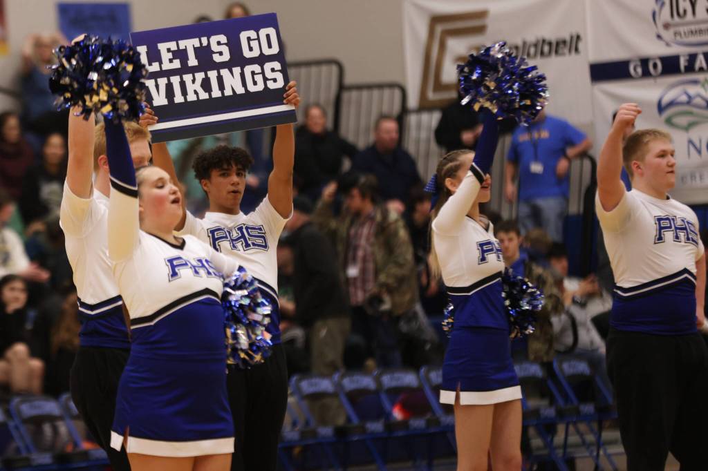 The Petersburg cheerleaders encourage their team at halftime. The performance brought those in attendance to their feet. (Ben Hohenstatt / Juneau Empire)
