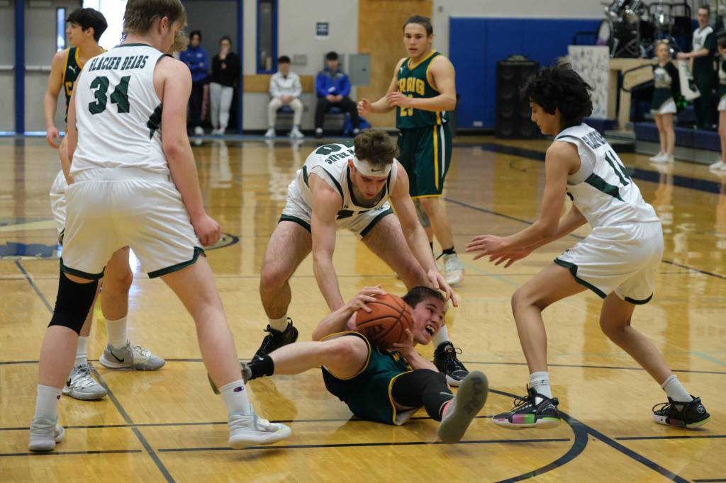 Craig High School junior Jayson Fowler (11) protects the ball from Haines High School seniors Eric Brouillette (40) and Garrette Stickler (34) and sophomore Alex Weerasinghe (11) during the Glacier Bears 68-39 win over the Panthers in the Region V 2A/4A Basketball Tournament on Wednesday, Mar. 8, 2023 at Thunder Mountain High School in Juneau. (Klas Stolpe / For the Juneau Empire)