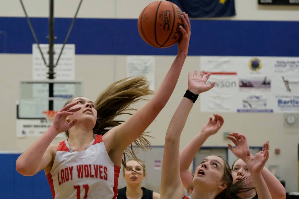 Wrangell High School senior Kiara Harrison (11) rebounds over senior teammate Trinity Faulkner (2) and Petersburg High School sophomores Iris Case (10) and Kylie Mattingly (30) during the Lady Wolves 48-10 win over the Lady Vikings in the Region V 2A/4A Basketball Tournament on Wednesday at Thunder Mountain High School in Juneau. (Klas Stolpe / For the Juneau Empire)
Wrangell High School senior Kiara Harrison (11) rebounds over senior teammate Trinity Faulkner (2) and Petersburg High School sophomores Iris Case (10) and Kylie Mattingly (30) during the Lady Wolves 48-10 win over the Lady Vikings in the Region V 2A/4A Basketball Tournament on Wednesday at Thunder Mountain High School in Juneau. (Klas Stolpe / For the Juneau Empire)