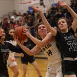 Craig senior Alissa Durgan (14) wills her way to the hoop while defended by Haines sophomore Ashlyn Ganey (32) and Haines senior Alison Benda (14) in the second half of a Craig win in the first round of the Region V 2A Tournament. (Ben Hohenstatt / Juneau Empire)