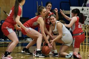 Metlakatla junior Ryley Booth battles for a loose ball with Wrangell sophomore Aubrey Wynne, senior Kiara Harrison, freshman Christina Johnson (12) and sophomore Addy Andrews (21) in the Region V 2A/4A Basketball Tournament on Thursday at Thunder Mountain High School in Juneau. (Klas Stolpe / For the Juneau Empire)