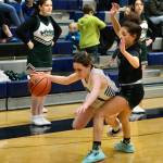 Petersburg junior Bryanna Ratliff is fouled by Haines sophomore Ariel Godinez Long during the Region V basketball tournament on Thursday. Haines eliminated Petersburg from the tournament 38-16. (Klas Stolpe / For the Juneau Empire)