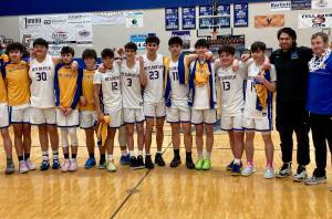 The Metlakatla Chiefs pose for a team photo after winning the Region V championship over Petersburg on Friday. (Klas Stolpe / For the Juneau Empire)