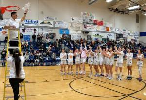 Metlakatla coach Julian Russell waves the MisChiefs Region V Championship net on Friday. (Klas Stolpe / For the Juneau Empire)