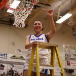 TMHS senior Kiara Kookesh holds up a strand from the net after securing the win against JDHS on Friday for the two teams final math up in the 4A Region V tournament. Kookesh tied for the lead in scoring with a total of 12 points. (Ben Hohenstatt / Juneau Empire)