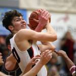 JDHS senior Orion Dybdahl rips down a board in a close contest against Ketchikan. The game took 36 minutes of gametime to resovle and ended 72-64 in Kayhis favor. The Crimson Bears and Kings will play for the Region V 4A title at 8:15 p.m. Saturday at Thunder Mountain High School. (Ben Hohenstatt / Juneau Empire)