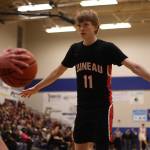 JDHS junior Sean Oliver (11) defends against an inbounds pass. Olivers hot shooting was crucial for the Crimson Bears. (Ben Hohenstatt / Juneau Empire)