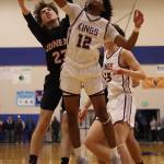 JDHS Joseph Aline (23) and Kayhi senior JJ Parker (12) battle for a board in the first half of the Region V 4A Championship game. (Ben Hohenstatt / Juneau Empire)