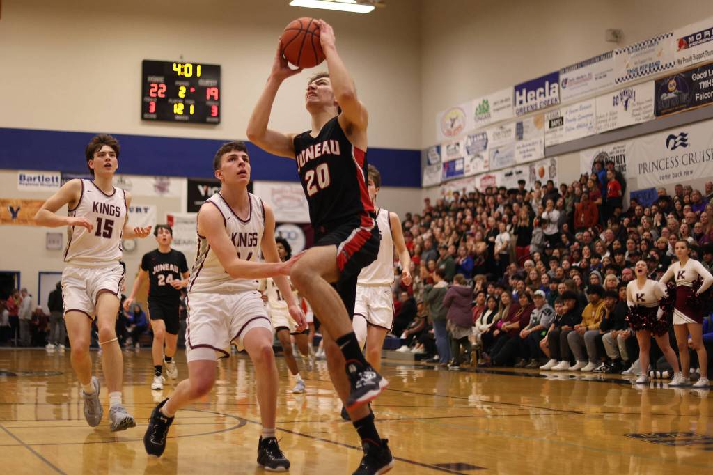JDHS senior Orion Dybdahl begins ascending for a dunk with Kayhis Jared Rhoads (15) and Marcus Stockhausen (34) in pursuit.