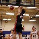 JDHS senior Orion Dybdahl finishes a dunk with authority as teammate Alwen Carrillo (3) and Kayhis Jared Rhoads (15), Marcus Stockhausen (34) and Andrew Kleinschmidt (13) look on. (Ben Hohenstatt / Juneau Empire)