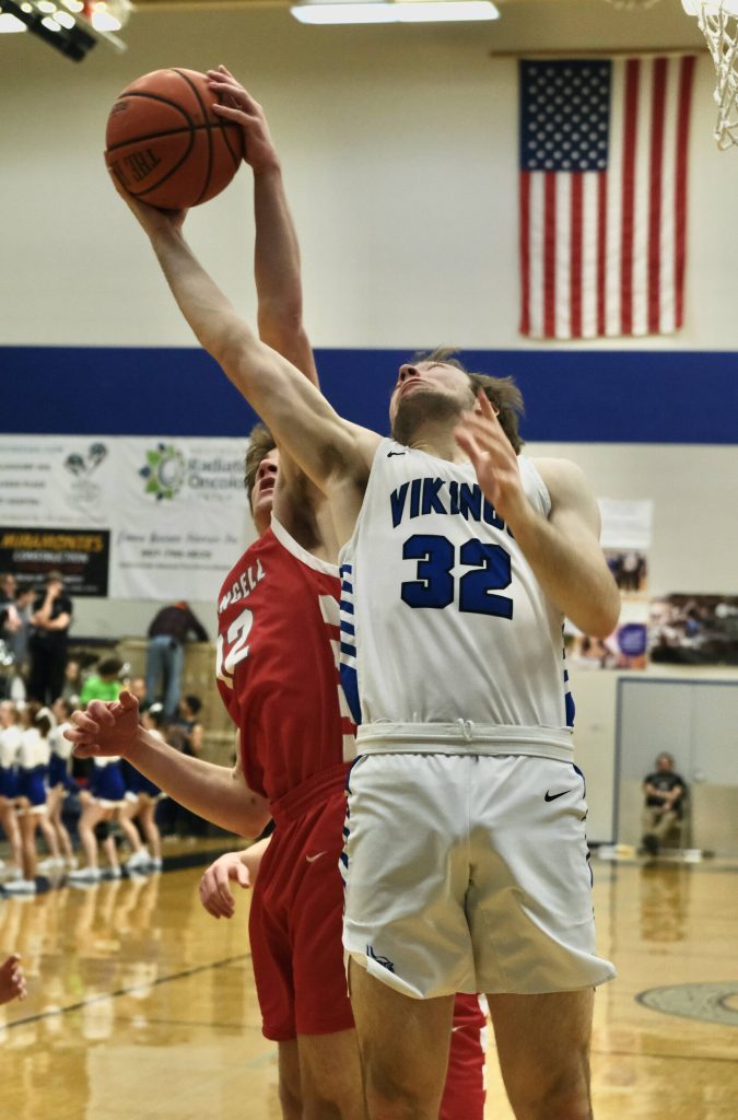 Wrangell senior Ethan Blatchley (12) blocks a shot by Petersburg senior Jack Engell (32) during the Wolves 45-41 win over the Vikings in the 2A Region V Runner Up game on Saturday at Juneaus Thunder Mountain High School. (Klas Stolpe / For the Juneau Empire)