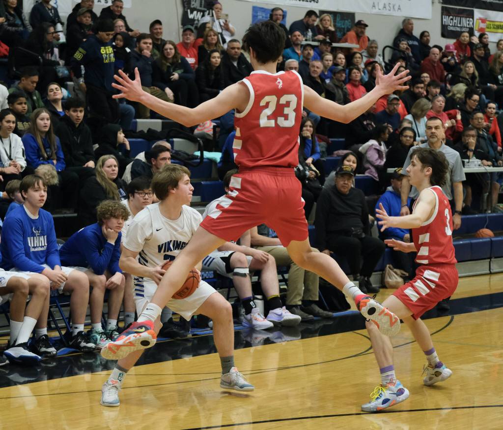 Wrangell seniors Jacen Hay (23) and Devlyn Campbell (3) defend Petersburg senior Owen Anderson during the Wolves 45-41 win over the Vikings in the 2A Region V Runner Up game on Saturday at Juneaus Thunder Mountain High School. (Klas Stolpe / For Juneau Empire)