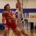Ben Hohenstatt / Juneau Empire 
Wrangell senior Ethan Blatchley (12) eyes the basket while tightly defended by Petersburg senior Jack Engell (32).