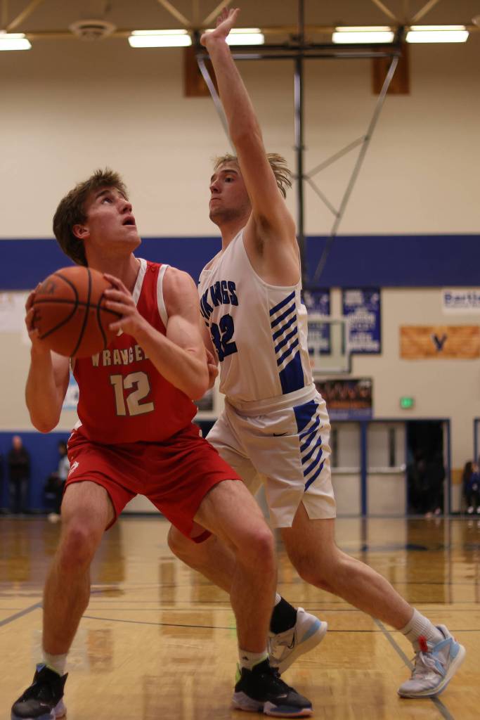 Ben Hohenstatt / Juneau Empire 
Wrangell senior Ethan Blatchley (12) eyes the basket while tightly defended by Petersburg senior Jack Engell (32).