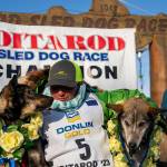 Ryan Redington poses with his lead dogs Sven, left, and Ghost, after he won the 2023 Iditarod Trail Sled Dog Race, Tuesday, March 14, 2023 in Nome, Alaska. Redington, 40, is the grandson of Joe Redington Sr., who helped co-found the arduous race across Alaska that was first held in 1973 and is known as the “Father of the Iditarod.”  (Loren Holmes / Anchorage Daily News)