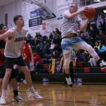 Juneaus Kaleb Tompkins boxes out while teammate Chase Saviers comes down with a rebound in the first half of a Juneau win against Kake in the first round of the Gold Medal Basketball Tournament. (Ben Hohenstatt / Juneau Empire)