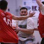 Juneau's Mahina Toutaiolepo peers through the arms of Kake defenders during the second half of a Juneau win in the Juneau Lions Club's 74th Gold Medal Basketball Tournament. (Ben Hohenstatt / Juneau Empire)