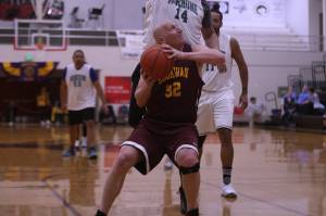 Klukwan's Brian Friske (32) coils up to take a shot at the hoop while defended by Yakutat's Dustin Endicott. (Ben Hohenstatt / Juneau Empire)