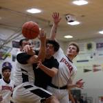 Spit flies as players from Metlakatla and Hoonah battle for the ball Sunday afternoon in the second B Bracket game of the 74th Juneau Lions Club Gold Medal Basketball Tournament. (Clarise Larson / Juneau Empire)