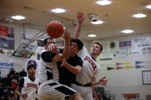 Spit flies as players from Metlakatla and Hoonah battle for the ball Sunday afternoon in the second B Bracket game of the 74th Juneau Lions Club Gold Medal Basketball Tournament. (Clarise Larson / Juneau Empire)