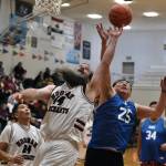 Hoonahs Mark Prpich (44) battles for a rebound with a Kake player during Masters Bracket action at the Juneau Lions Club 74th Annual Gold Medal Basketball Tournament, Sunday, March 19, at the Juneau-Douglas High School: Yadaa.at Kalé gymnasium. (Klas Stolpe / For the Juneau Empire)