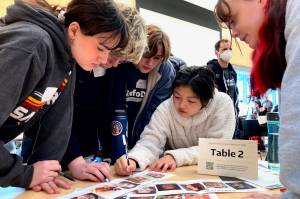 Ballard High School students work together to solve an exercise at MisinfoDay, an event hosted by the University of Washington to help high school students identify and avoid misinformation, Tuesday, March 14, 2023, in Seattle. Educators around the country are pushing for greater digital media literacy education. (AP Photo / Manuel Valdes)