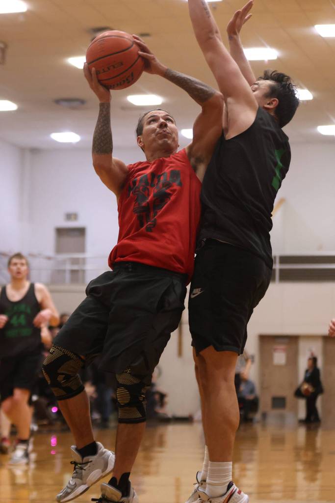 Hydaburgs TJ Young hoists a contested shot in the restricted area in the first half of Hydaburgs 18-point win against Haines. (Ben Hohenstatt / Juneau Empire)