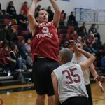 Klukwans Jeff Forbes (5) scores over Hoonahs Louie White Jr. (35) during Masters Bracket action in the Gold Medal Basketball Tournament, Monday, March 20, at Juneau-Douglas High School: Yadaa.at Kalé. (Klas Stolpe/For the Juneau Empire)