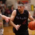 Hoonahs Braxton Booze (23) looks to drive to the hoop while defended by Filcoms Alex Huemann(24) during the second half of a Filcom win. (Ben Hohenstatt / Juneau Empire)