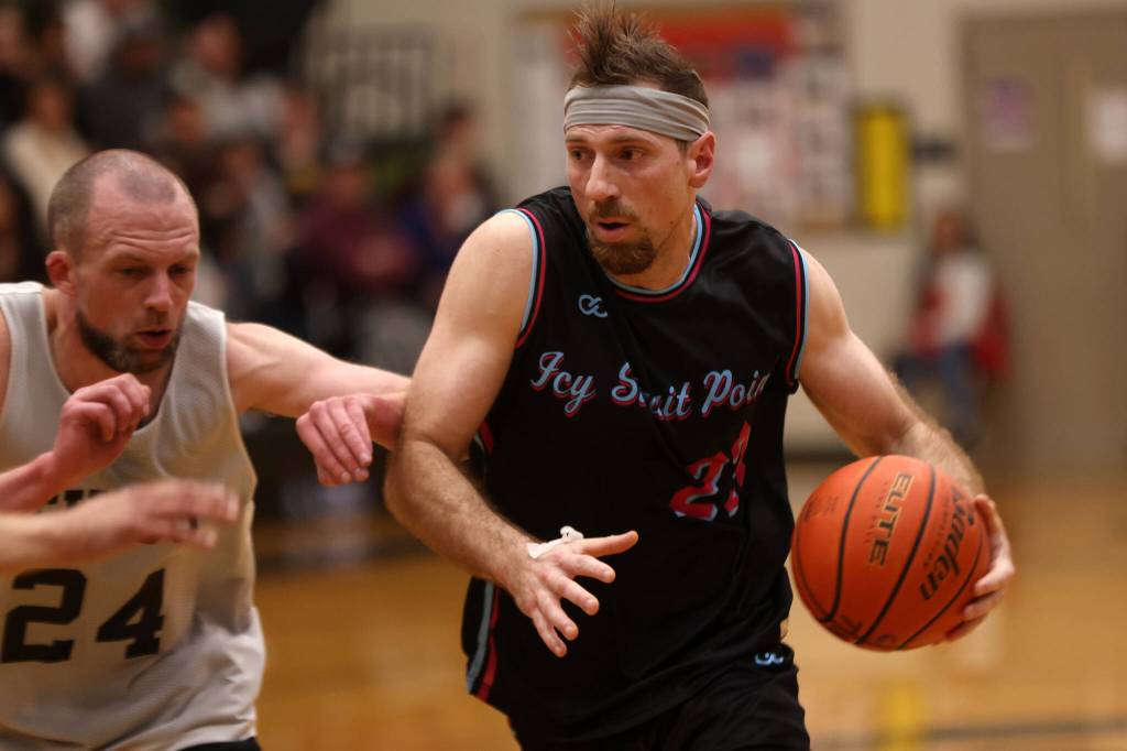 Hoonahs Braxton Booze (23) looks to drive to the hoop while defended by Filcoms Alex Huemann(24) during the second half of a Filcom win. (Ben Hohenstatt / Juneau Empire)