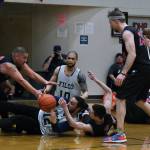 Hoonah and Filcom players battle for a loose ball during C Bracket action in the Gold Medal Basketball Tournament, Monday, March 20, at Juneau-Douglas High School: Yadaa.at Kalé. (Klas Stolpe/For the Juneau Empire)