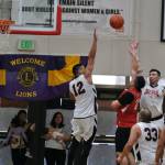 Kakes Charles Jackson (21) makes the final game winning shot on Tuesday against Hoonah during overtime to secure Kakes advancement in this years Gold Medal basketball tournament. (Klas Slope / For the Juneau Empire)