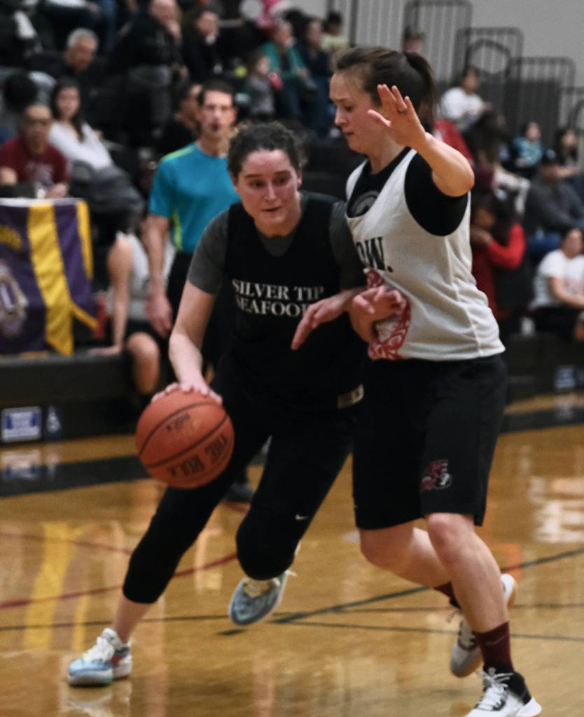 Sitkas Lexi Smit drives against Prince of Wales Nani Weimer at the Gold Medal tournament, Tuesday, March 21, in the Juneau-Douglas High School: Yadaa.at Kalé gymnasium. (Klas Stolpe/For the Juneau Empire)