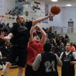 Angoons Ivan Raney (22) reaches for a rebound over Kakes Jess Ross during C Bracket action in the Gold Medal Basketball Tournament, Tuesday, March 21, at Juneau-Douglas High School: Yadaa.at Kalé. (Klas Stolpe / For the Juneau Empire)