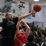 Angoons Ivan Raney (22) reaches for a rebound over Kakes Jess Ross during C Bracket action in the Gold Medal Basketball Tournament, Tuesday, March 21, at Juneau-Douglas High School: Yadaa.at Kalé. (Klas Stolpe/For the Juneau Empire)
