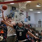 Angoons Anthony Snow shoots against Yakutats Robert Sensmeier (8) during the Gold Medal tournament, Tuesday, March 21, at Juneau-Douglas High School: Yadaa.at Kalé. (Klas Stolpe / For the Juneau Empire)