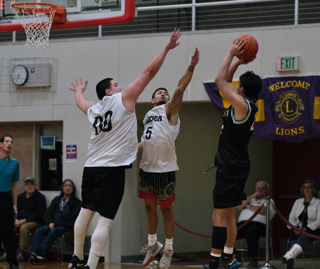 Angoons Kendrick Payton (00) and Aquino Brinson (5) defend a shot by Yakutats Christian Adams during the Gold Medal Baseball Tournament, Tuesday, March 21, at Juneau-Douglas High School: Yadaa.at Kalé. (Klas Stolpe / For the Juneau Empire)